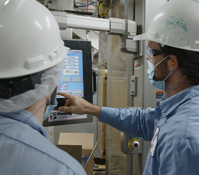 Two Blue Buffalo Workers Looking at Screen